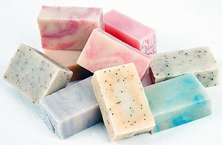 Soap bars with different colors and patterns in a pile.