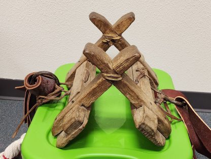 a wooden object with bars across and small bars crossing at each end