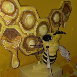 a crafted bee on a painted honeycomb